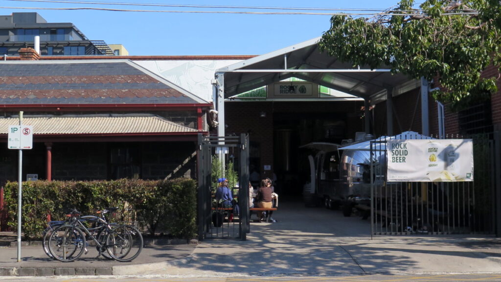The unassuming front entrance of Rocky Ridge Brunswick, with minimal signage and and airstream trailer parked inside